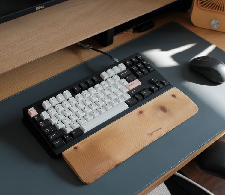 Modern ergonomic desk setup with keyboard wrist rest, showing comfortable typing posture and office productivity benefits