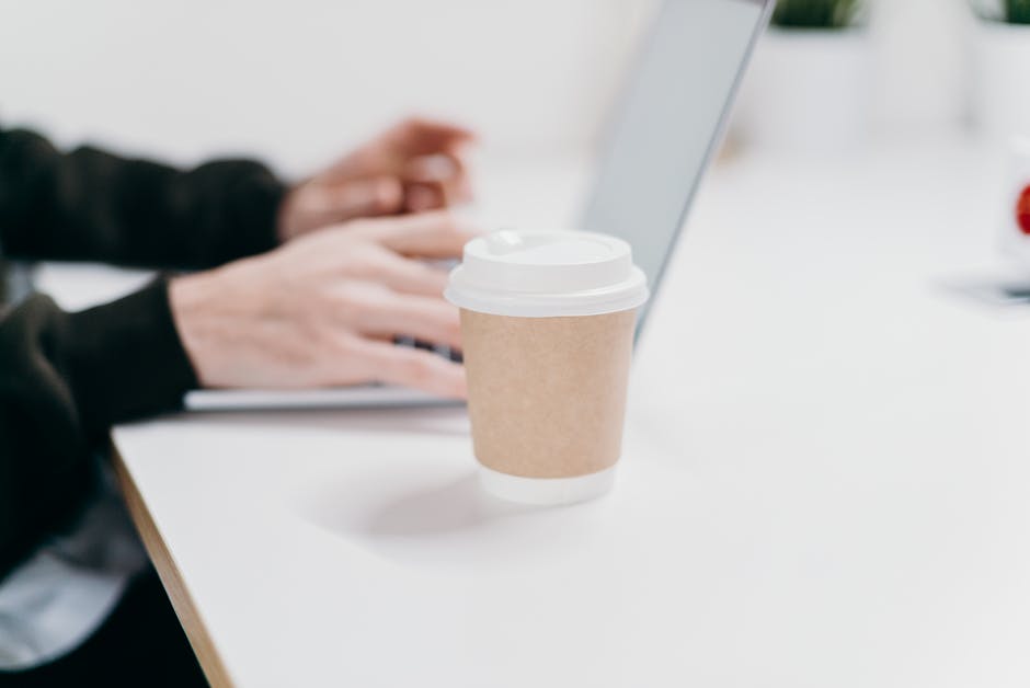 Modern office worker typing with ergonomic wrist rest, evaluating desk setup to reduce wrist pain and prevent repetitive strain in 2026
