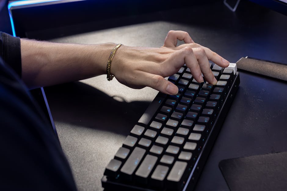Modern ergonomic office desk with worker using neutral wrist position at keyboard and mouse to reduce strain and support wrist health