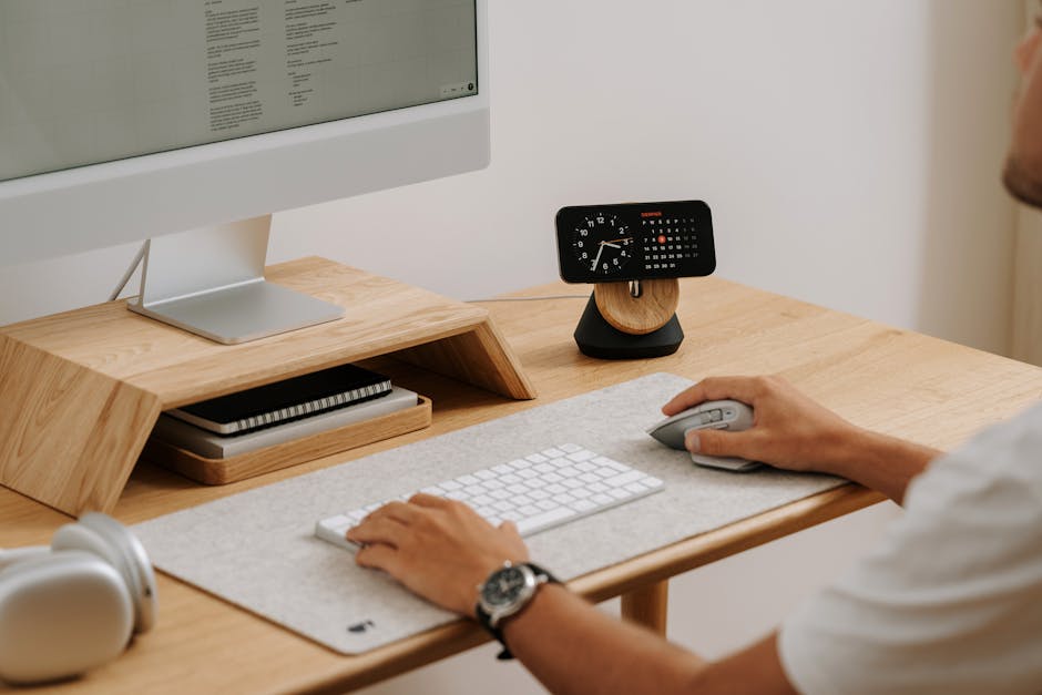 Professional at computer using ergonomic desk setup and elbow support ...